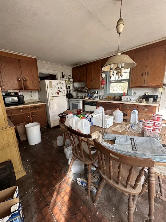 Tolland Stage kitchen before renovation, with wood cabinets and a dining table.